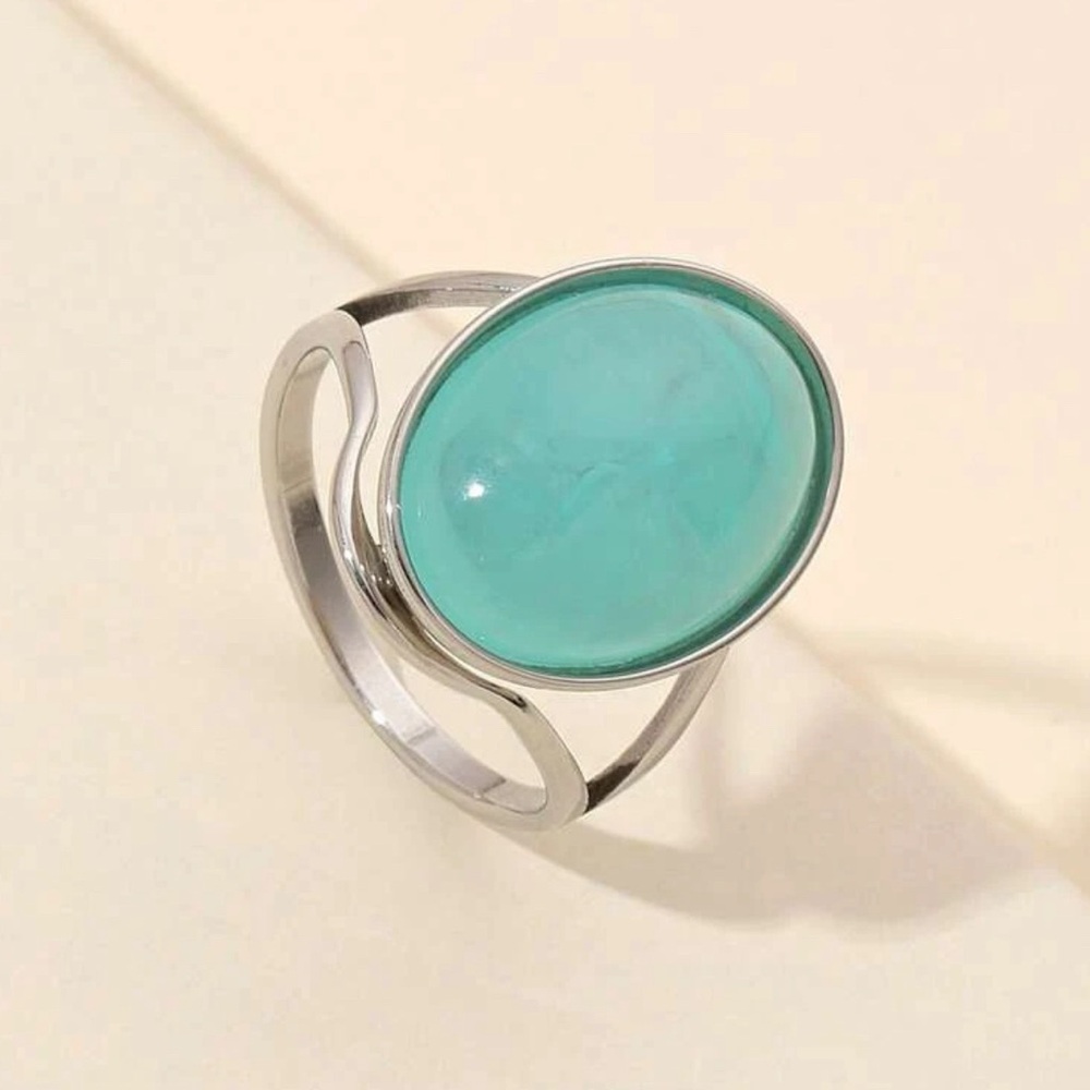 Light blue gemstone and stainless steel ring.